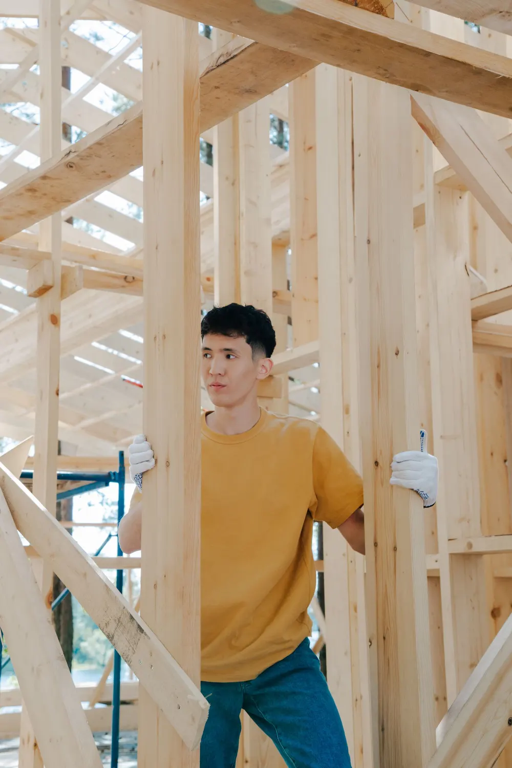 Carpenter working inside a timber-framed house