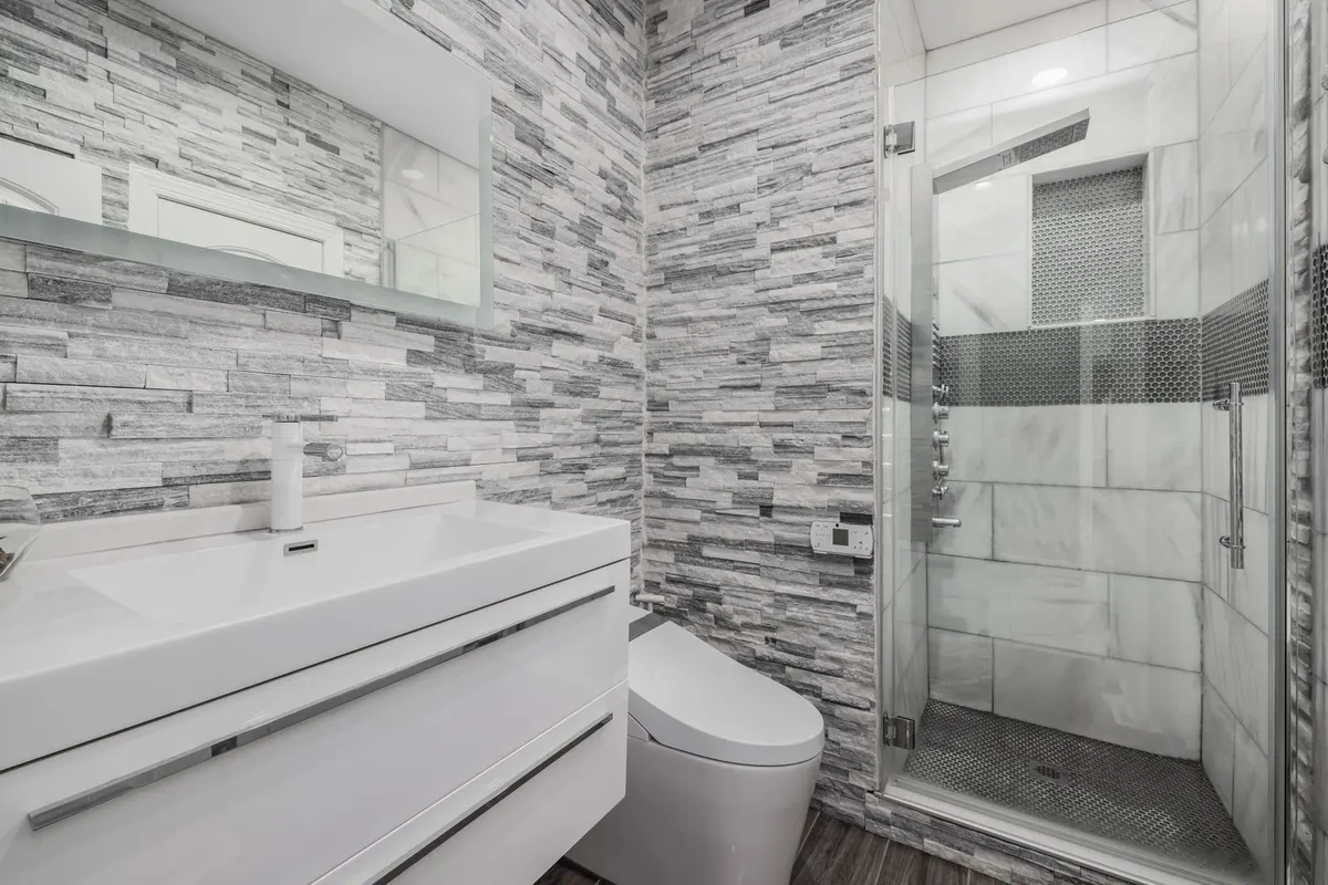 Modern bathroom with stone tile and glass shower
