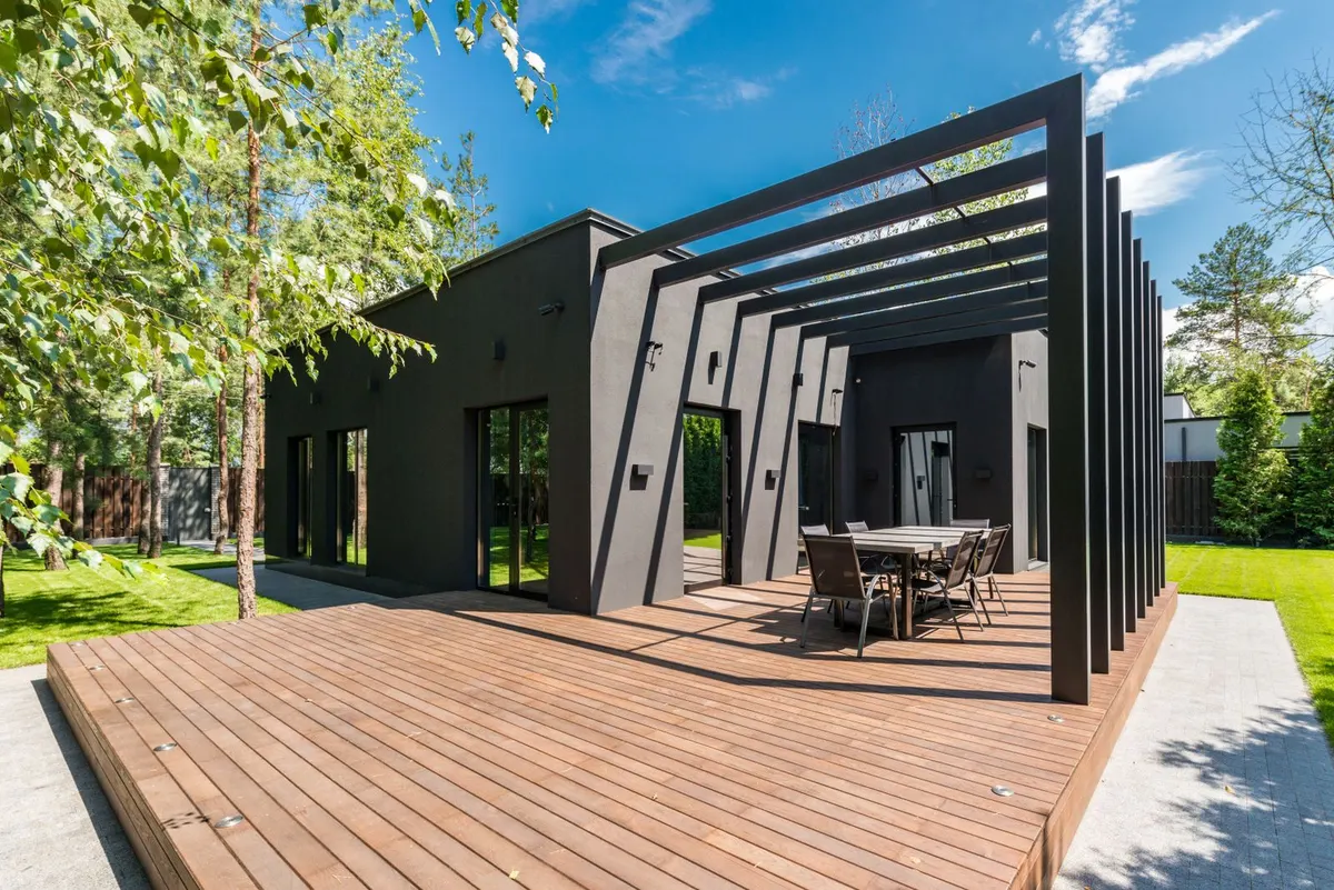 New wood deck and pergola behind a modern home